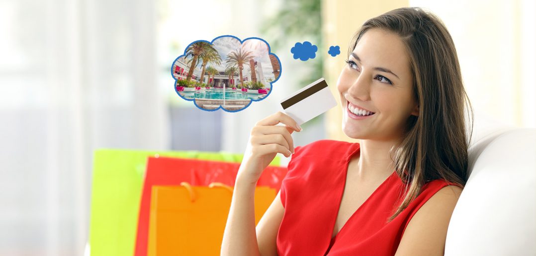 Elinde kredi kartı ile tatil düşünen bir kadın